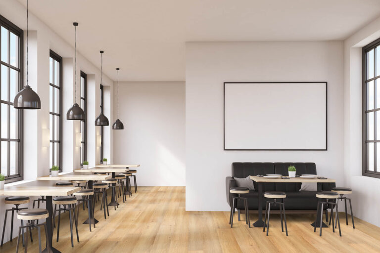 Cafe interior with a large sofa near a white wall, a row of tables with chairs near windows and a big horizontal poster on the wall, wooden floor. 3d rendering. Mock up.